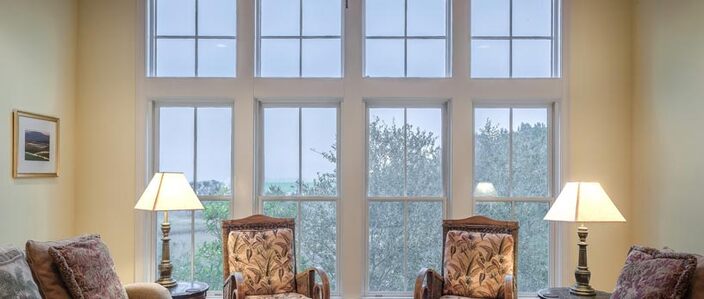 window of a living room with sliding windows and old styled furniture
