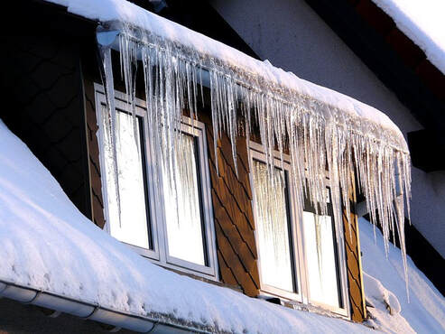 picture of a windows behind some icicles