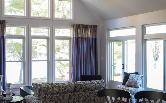 Window of a living room with purple curtains and sliding doors