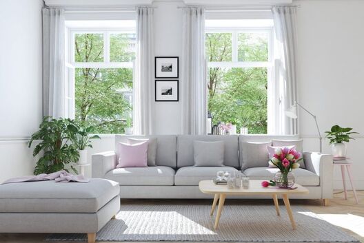 Gray interior with gray couch and oak table