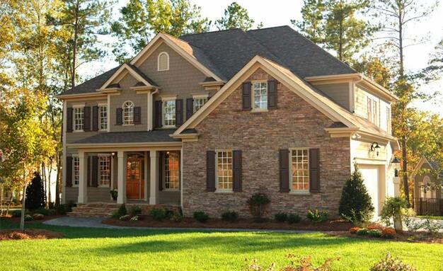 Stone brick house with lots of windows and nice sunrise